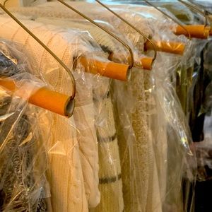 Long sleeved, button down sweater with scalloped hem/sleeves.